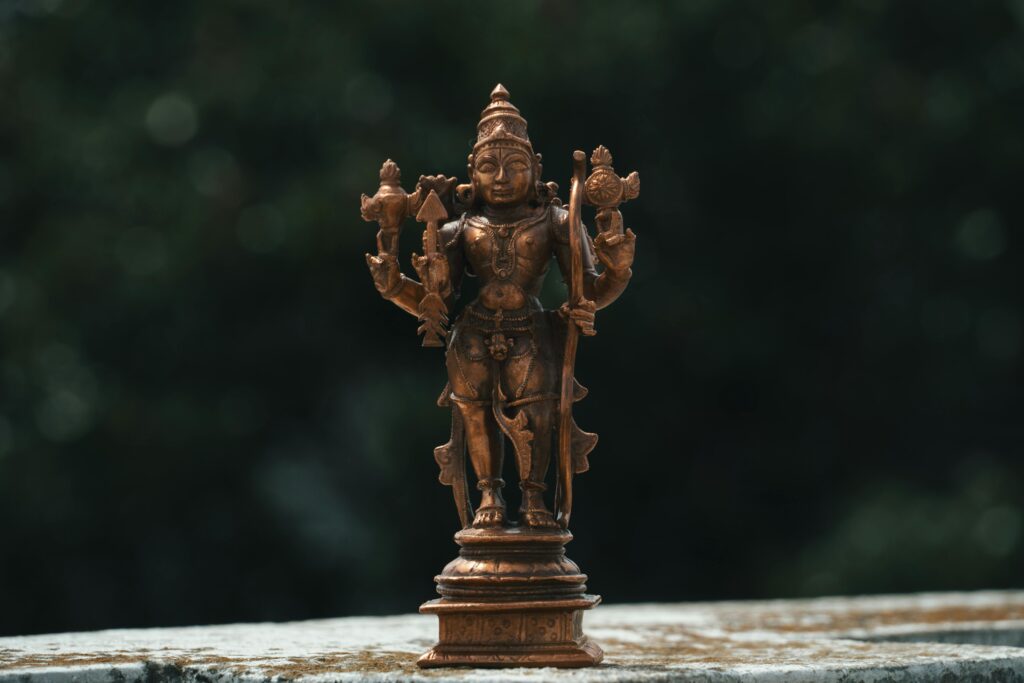 Hindu Deity Copper Statue in Close Up Photography
